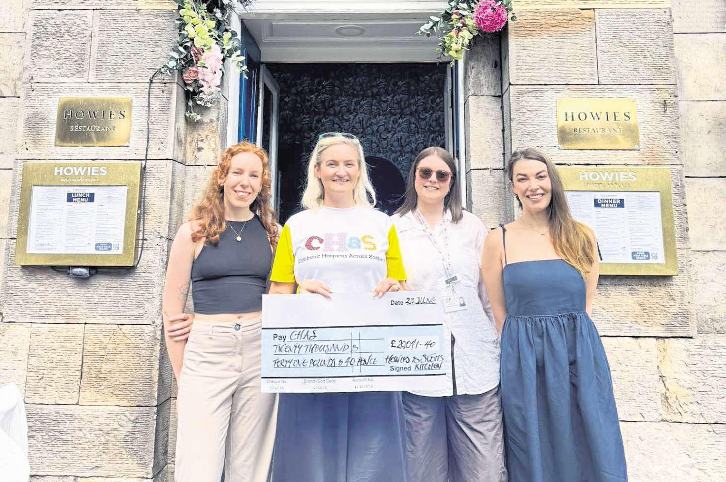 Howies team with fundraising cheque for CHAS