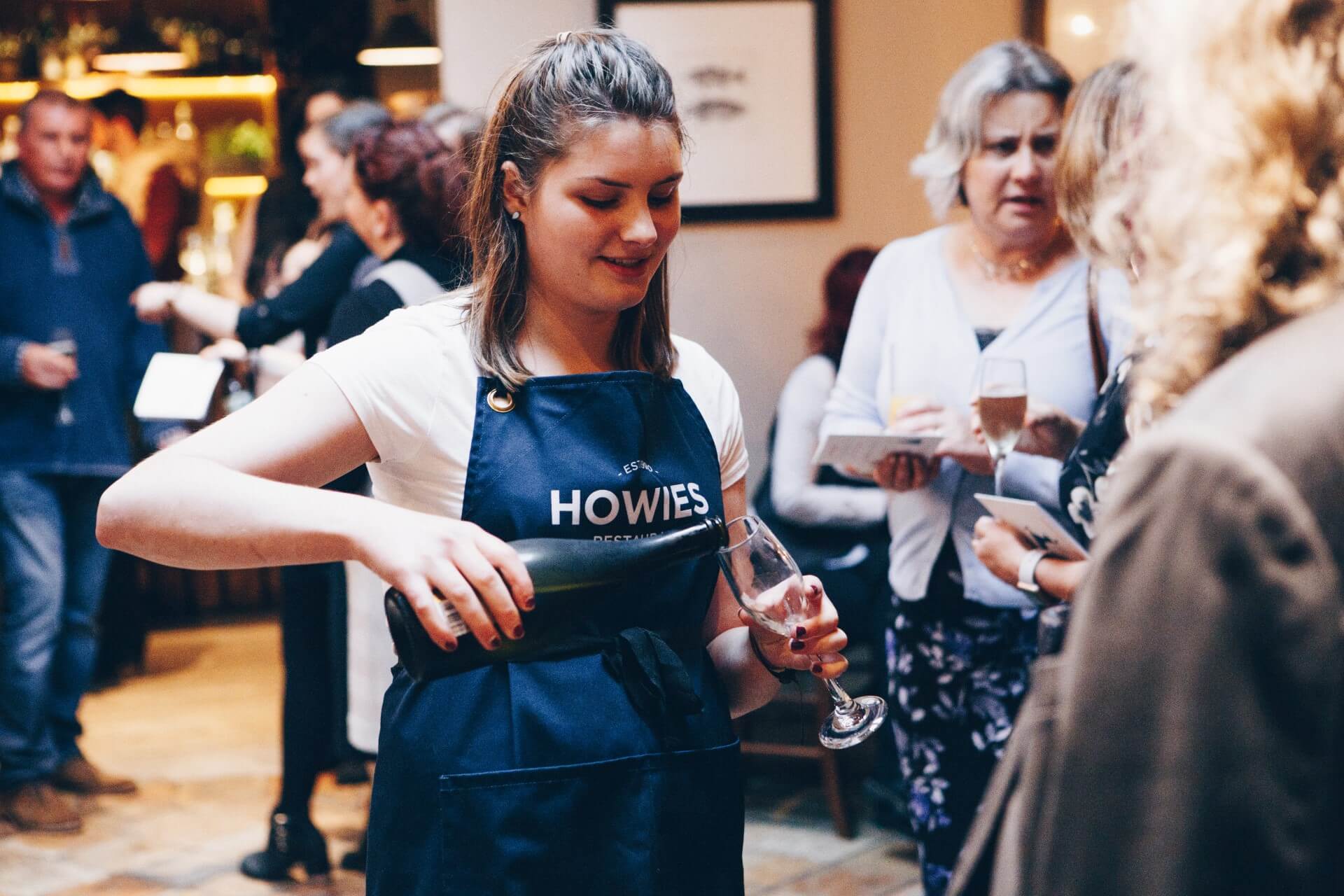 Howies server pouring drinks