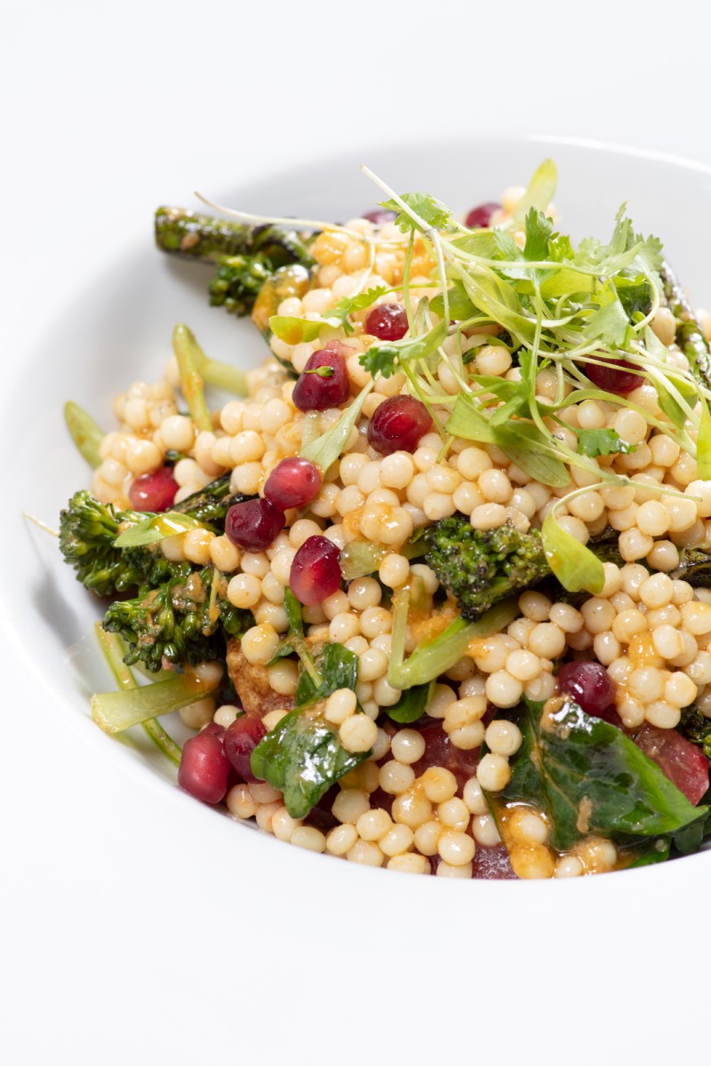 Salad with cous cous, broccoli and pomegranate seeds